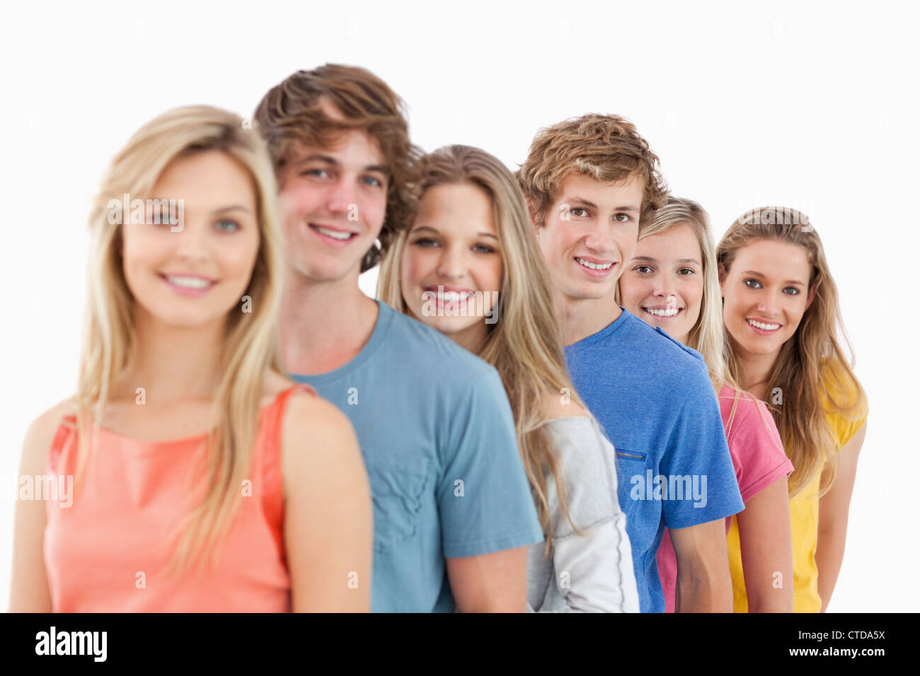 A smiling group standing behind each other at an angle Stock Photo - Alamy