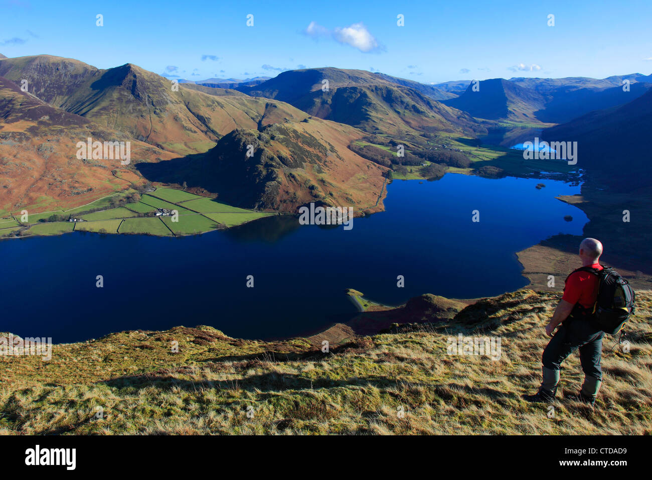 Male walker overlooking Crummock Water and the Buttermere valley, Lake District National Park, Cumbria County, England, UK Stock Photo