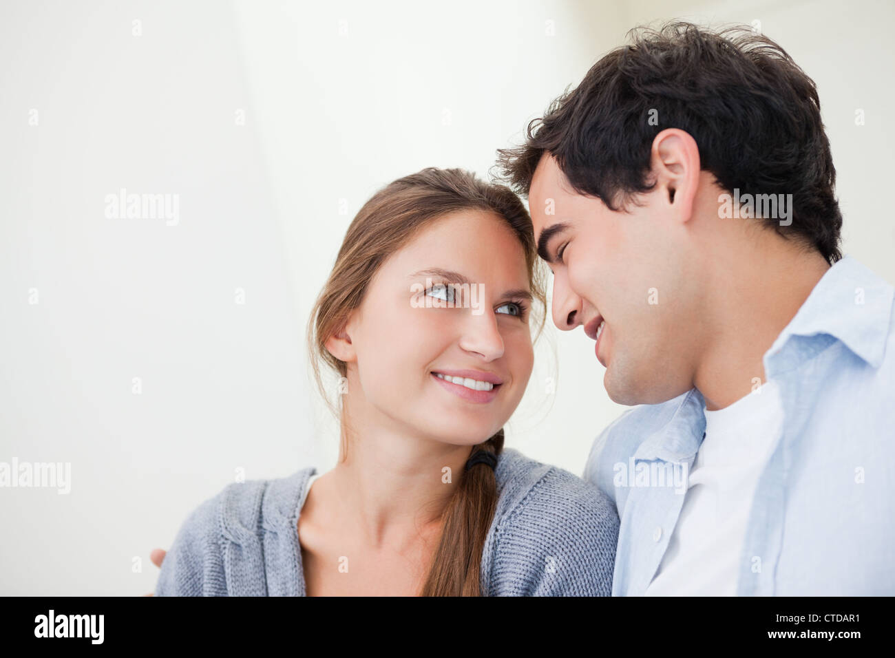 Couple smiling while embracing each other Stock Photo - Alamy