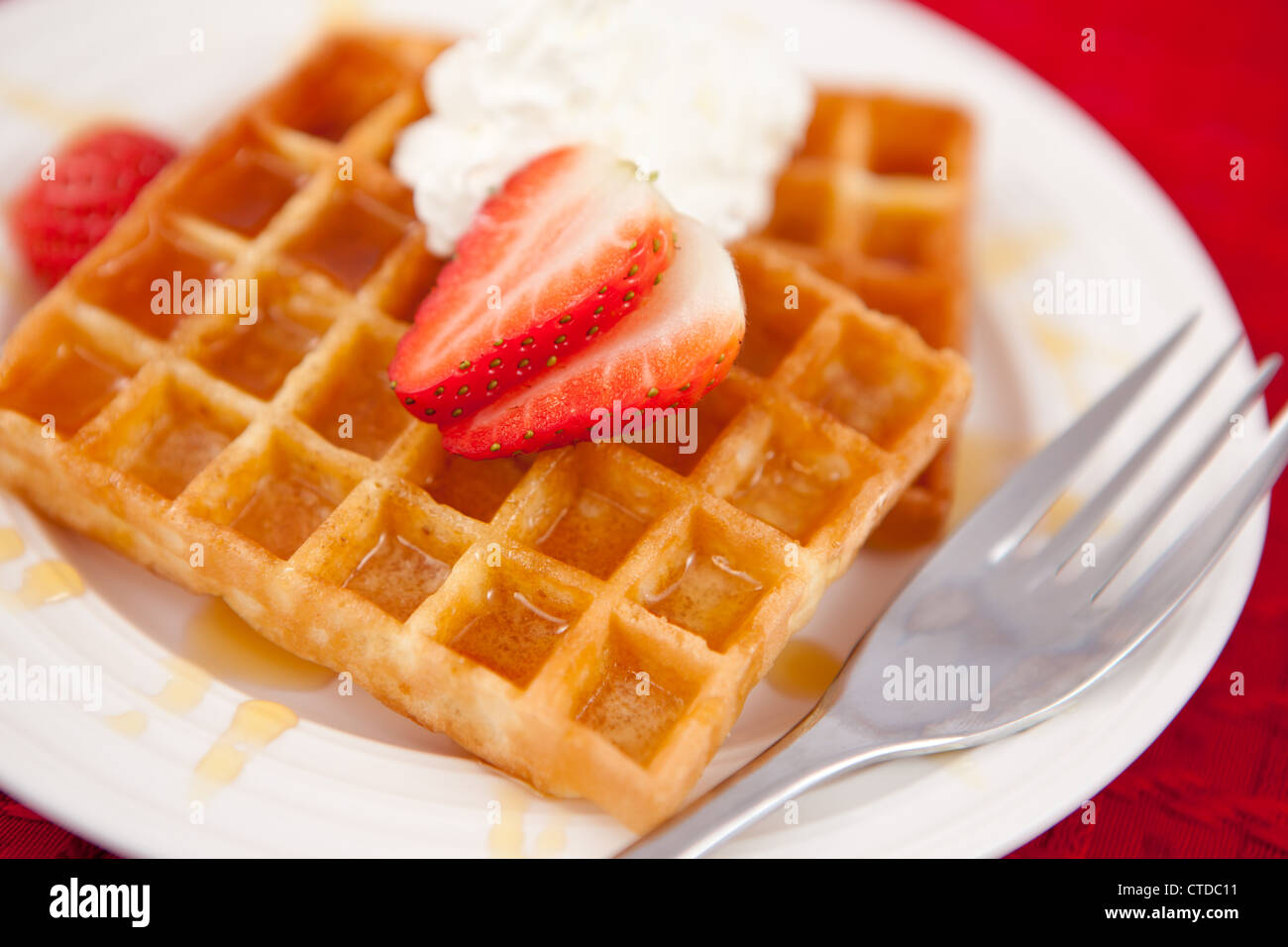 Waffles with whipped cream and strawberry on it Stock Photo - Alamy