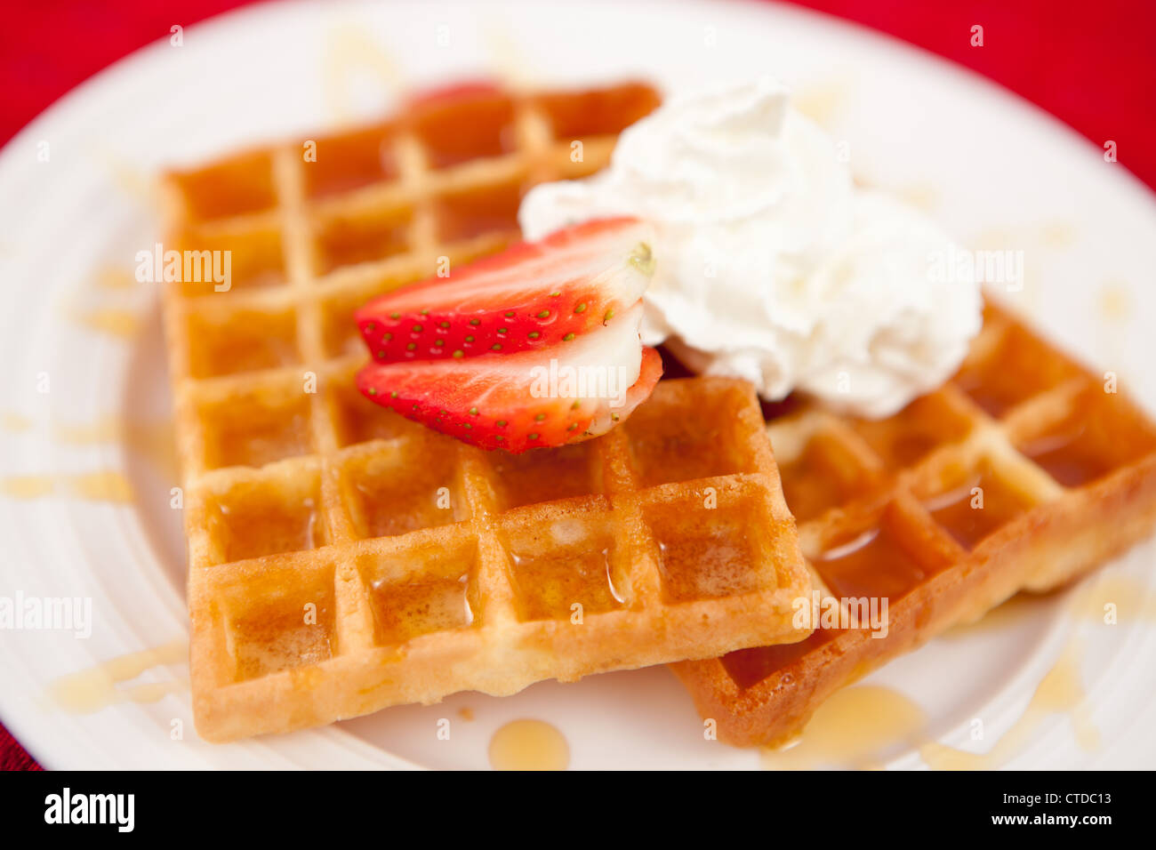 Waffles with whipped cream and strawberry and syrup Stock Photo - Alamy