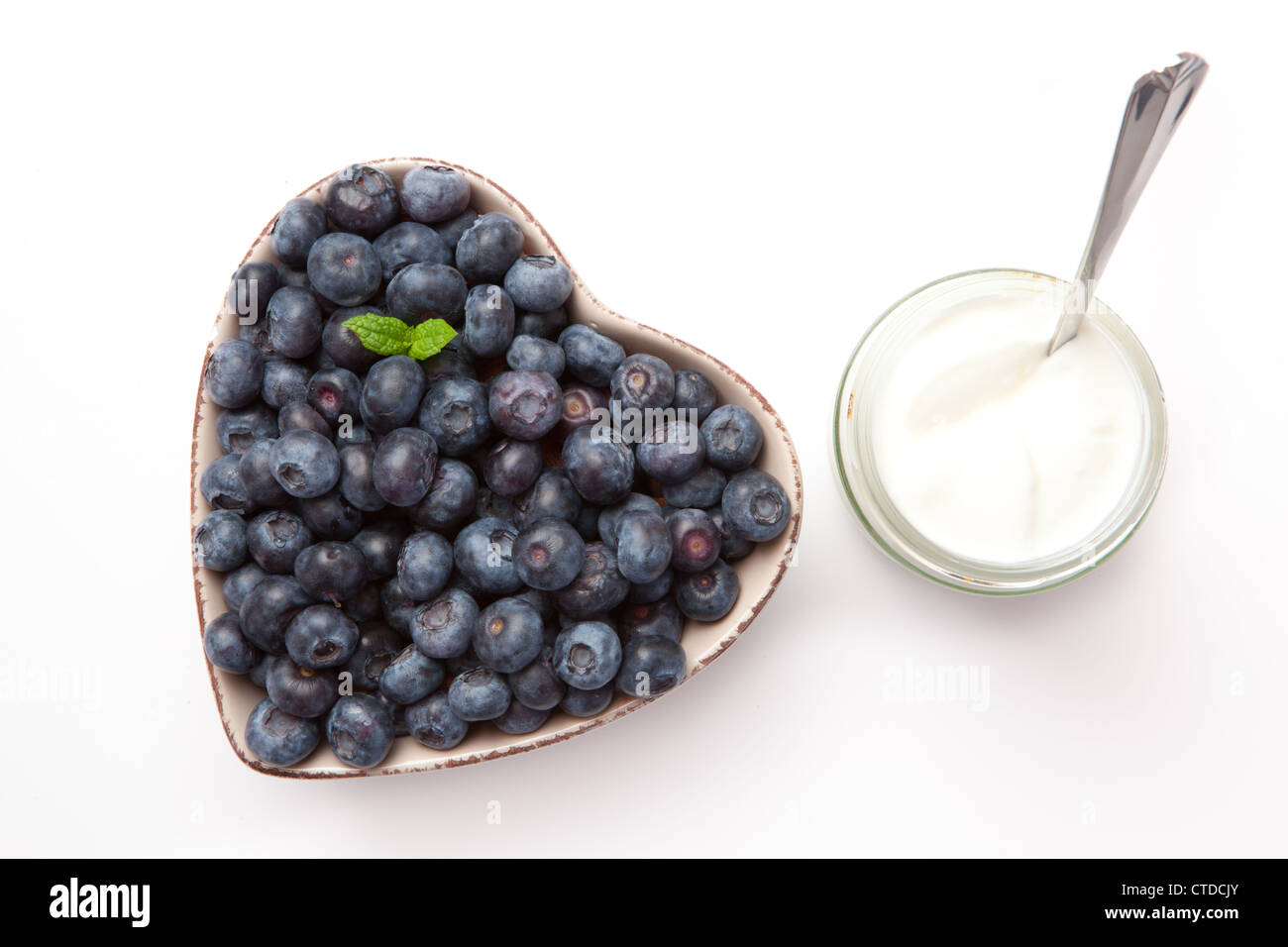 White yogurt and blueberries in a bowl Stock Photo