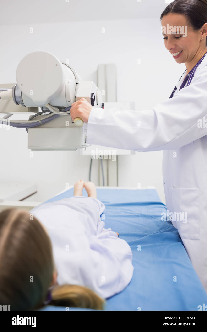 Smiling female doctor doing a radiography on a patient Stock Photo