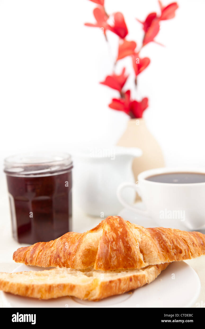Breakfast with a bisected croissant Stock Photo
