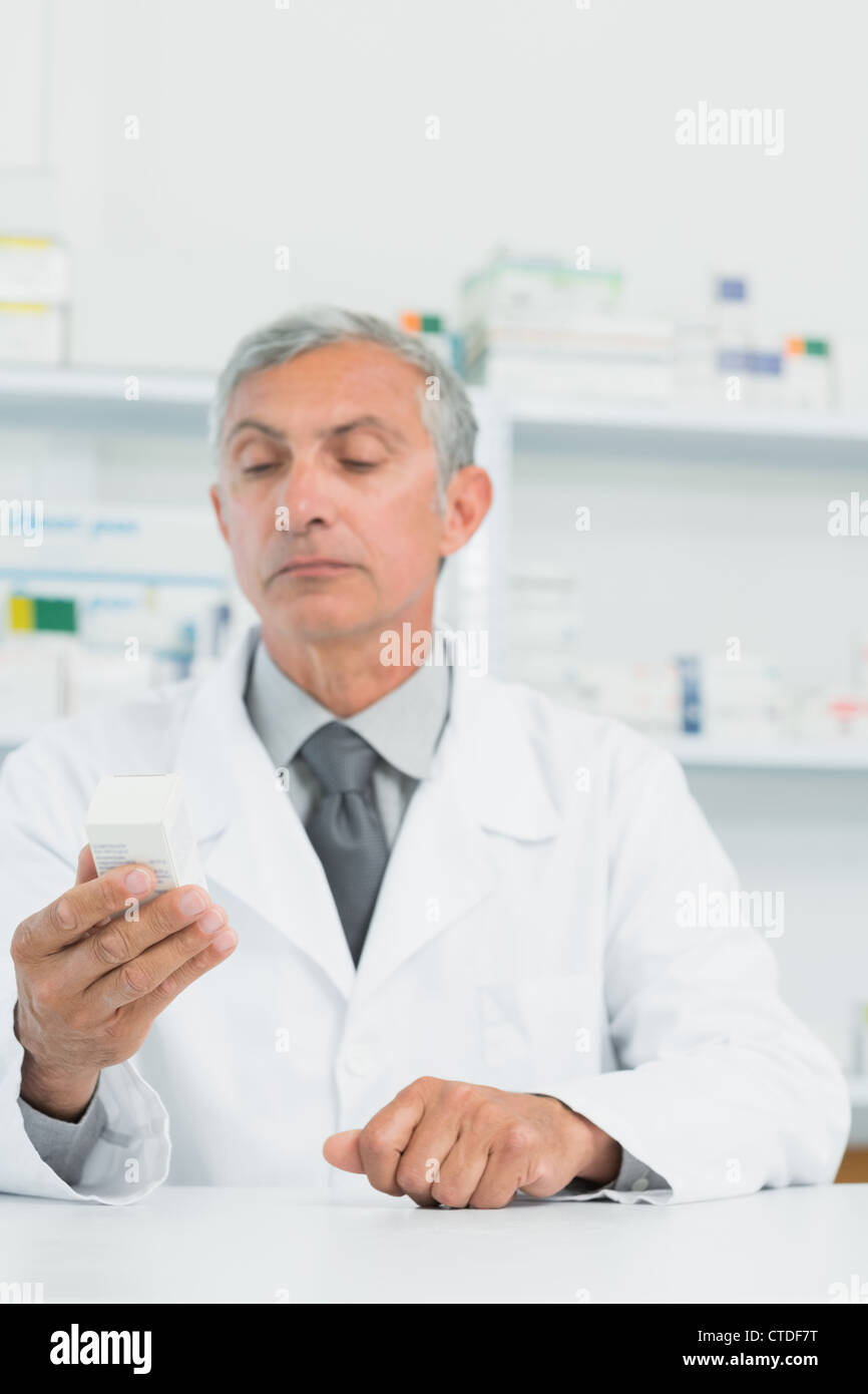 Pharmacist holding a box full of pills Stock Photo