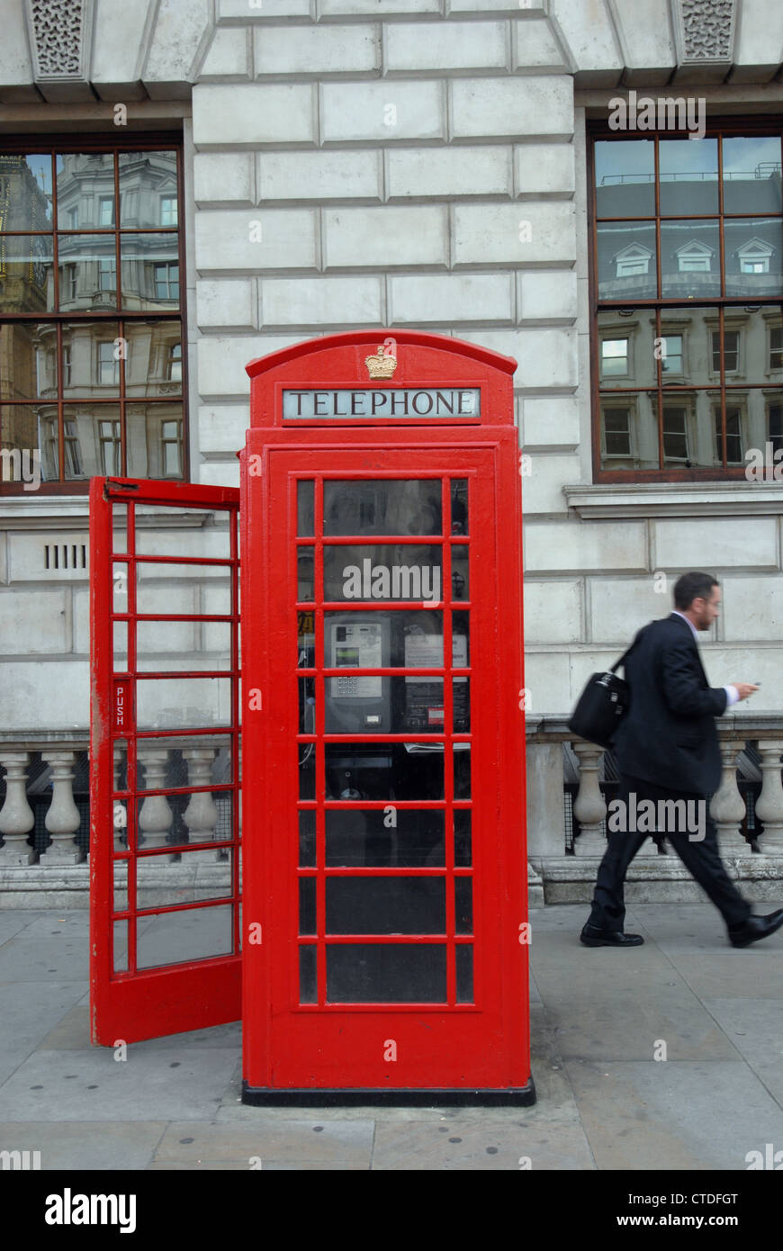 Traditional British telephone box  in Whitehall London with its door open Stock Photo