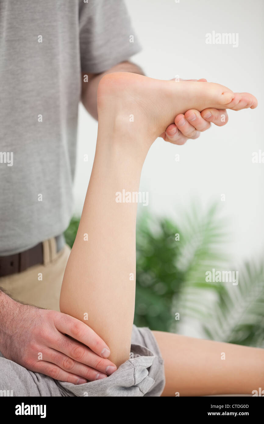 Woman lying forward while being stretched Stock Photo - Alamy