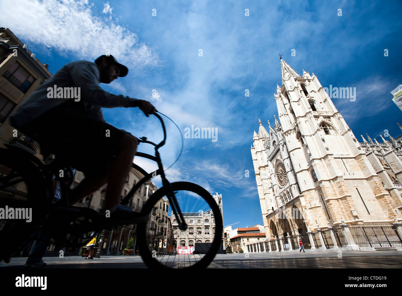 Cyclist passing by the Cathedral, town of Leon, autonomous community of Castilla y Leon, northern Spain Stock Photo