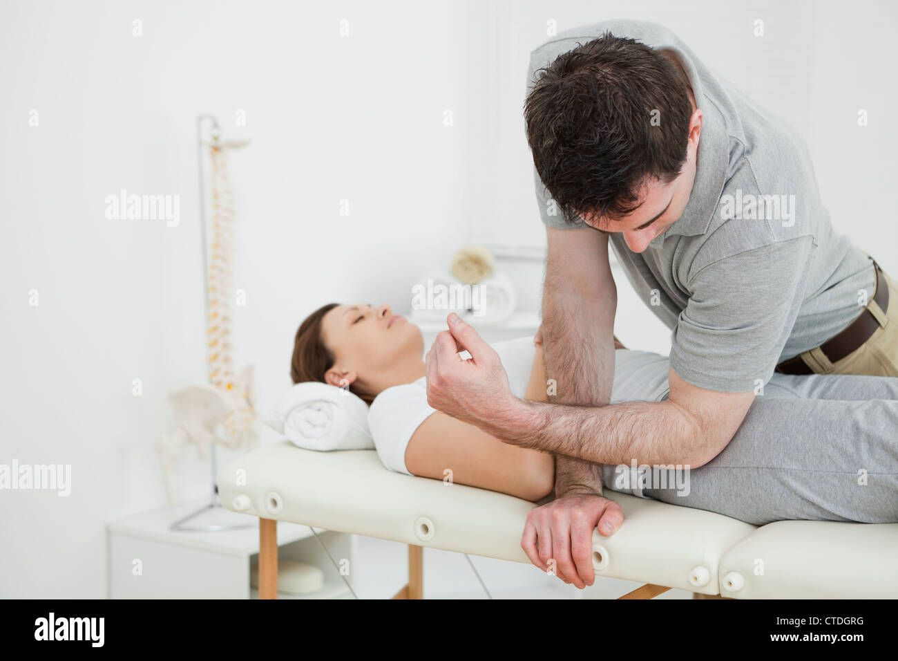 Physiotherapist massaging the pelvis of a woman Stock Photo