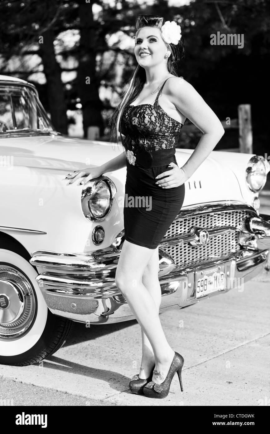 Female woman dressed in a rockabilly fashion posing next to a classic  vehicle Stock Photo - Alamy