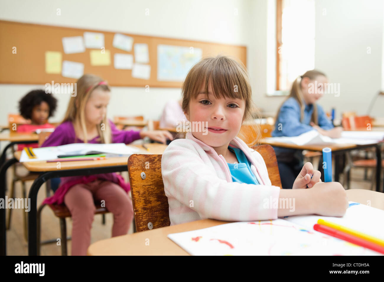 Girl drawing during class Stock Photo - Alamy