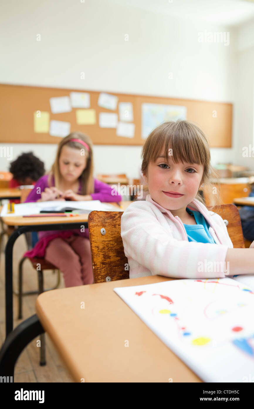 Girl at desk with drawing book Stock Photo - Alamy