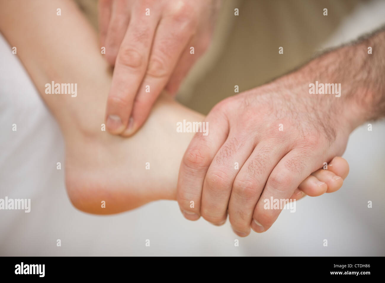 Physiotherapist massaging a barefoot Stock Photo
