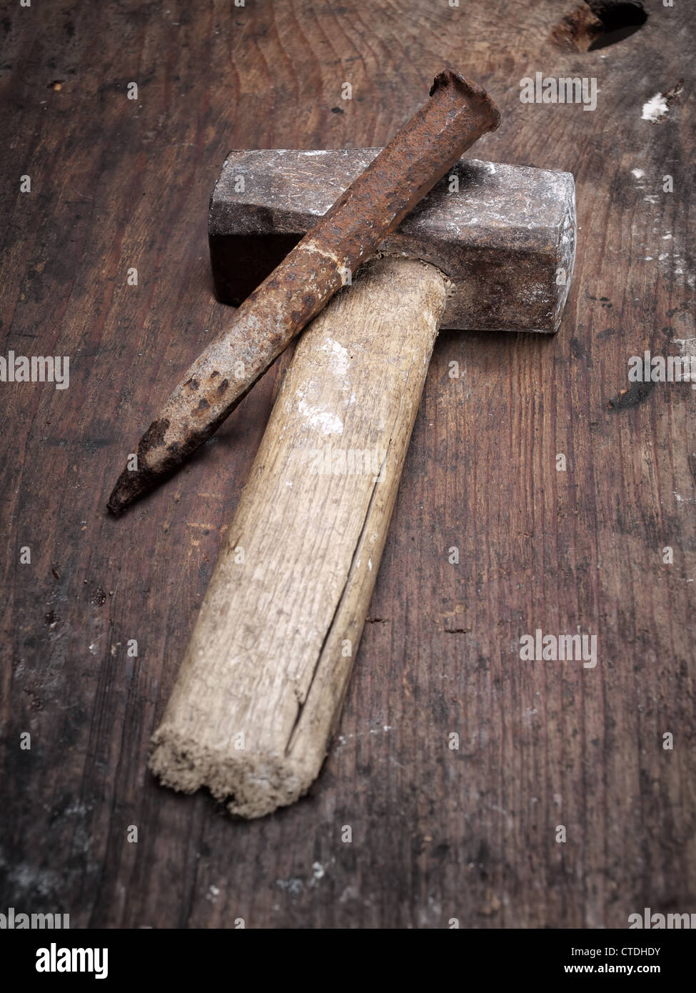 Old used hammer and chisel on a wooden background. Stock Photo