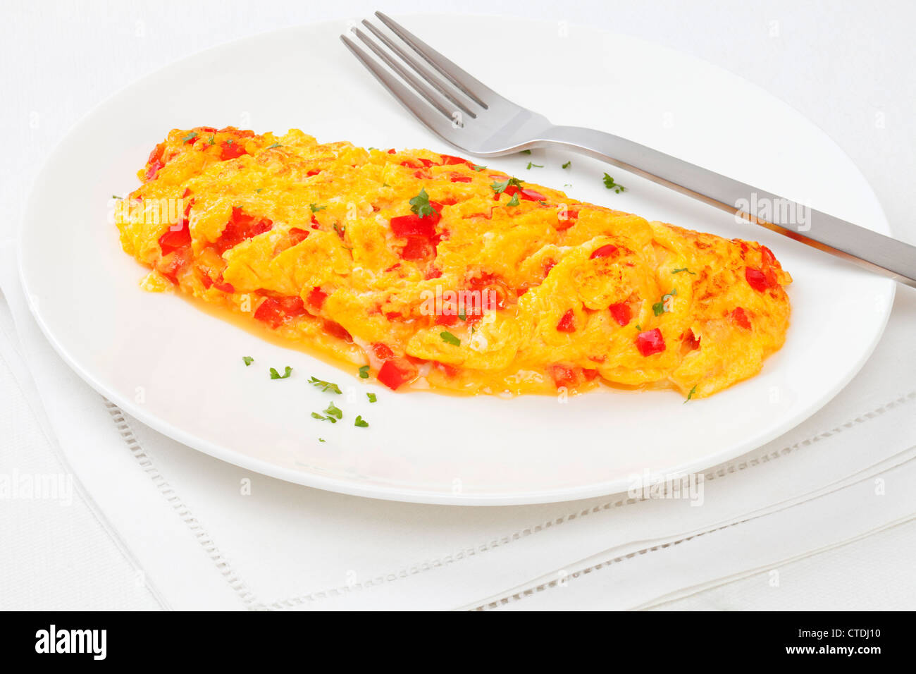 Tasty French omelette with cheese and red capsicum. Stock Photo