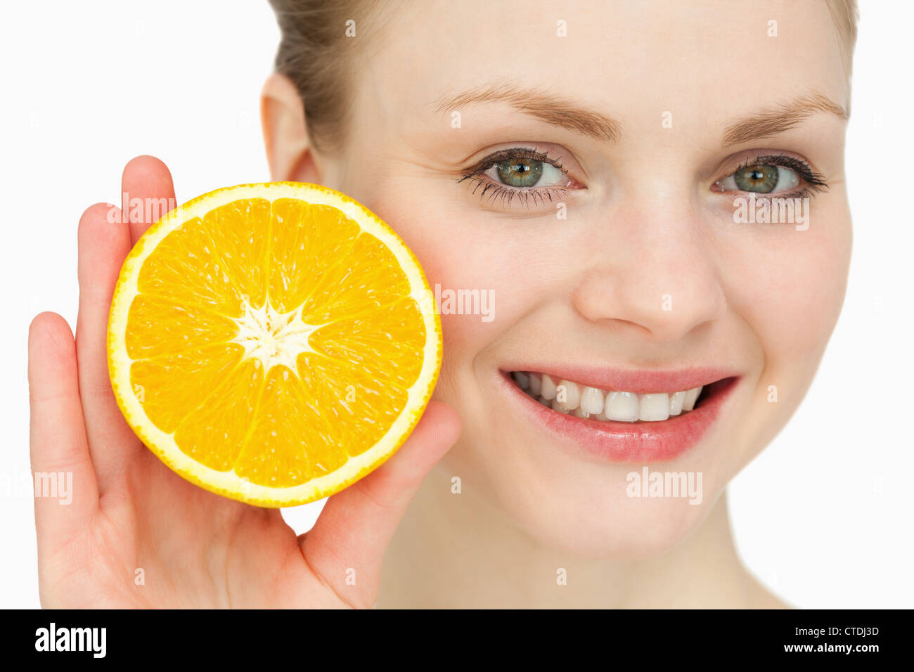 Blond-haired woman presenting an orange Stock Photo
