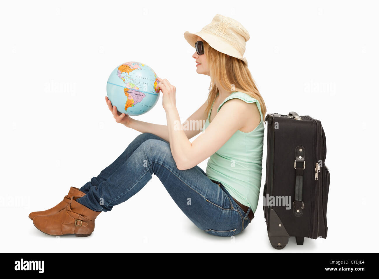 Woman holding a world globe while sitting Stock Photo