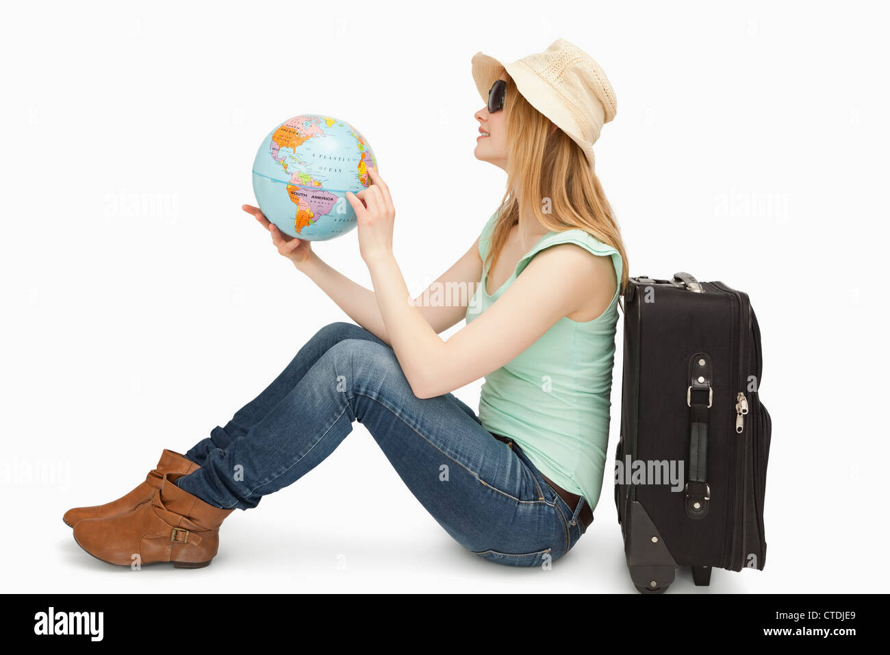 Woman sitting while holding a world globe Stock Photo