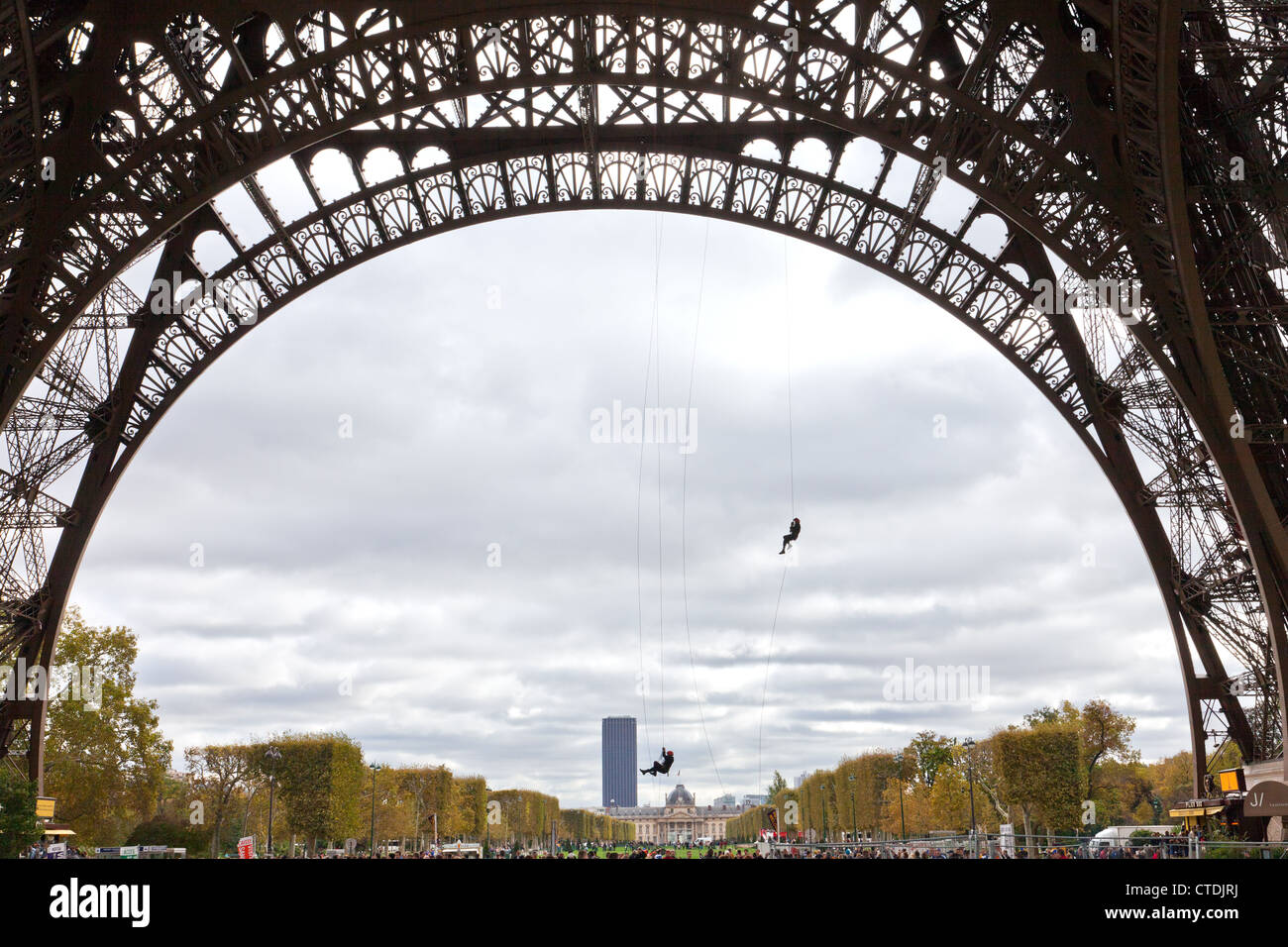 Paris, France: Paris firemen practice their skills from a base arch of the Eiffel Tower. Stock Photo