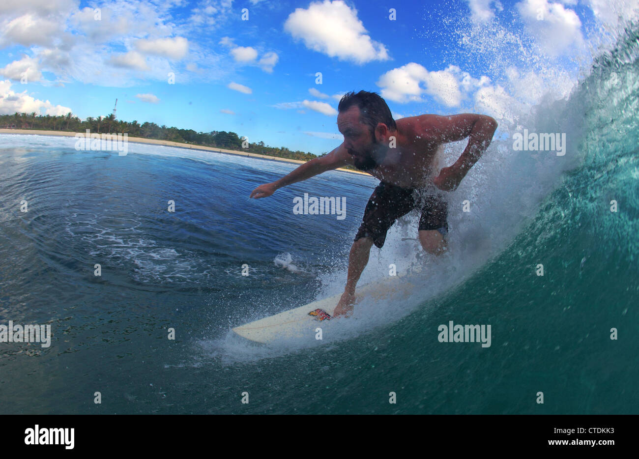 Water view of a tourist surfing in Krui, Sumatra. Stock Photo