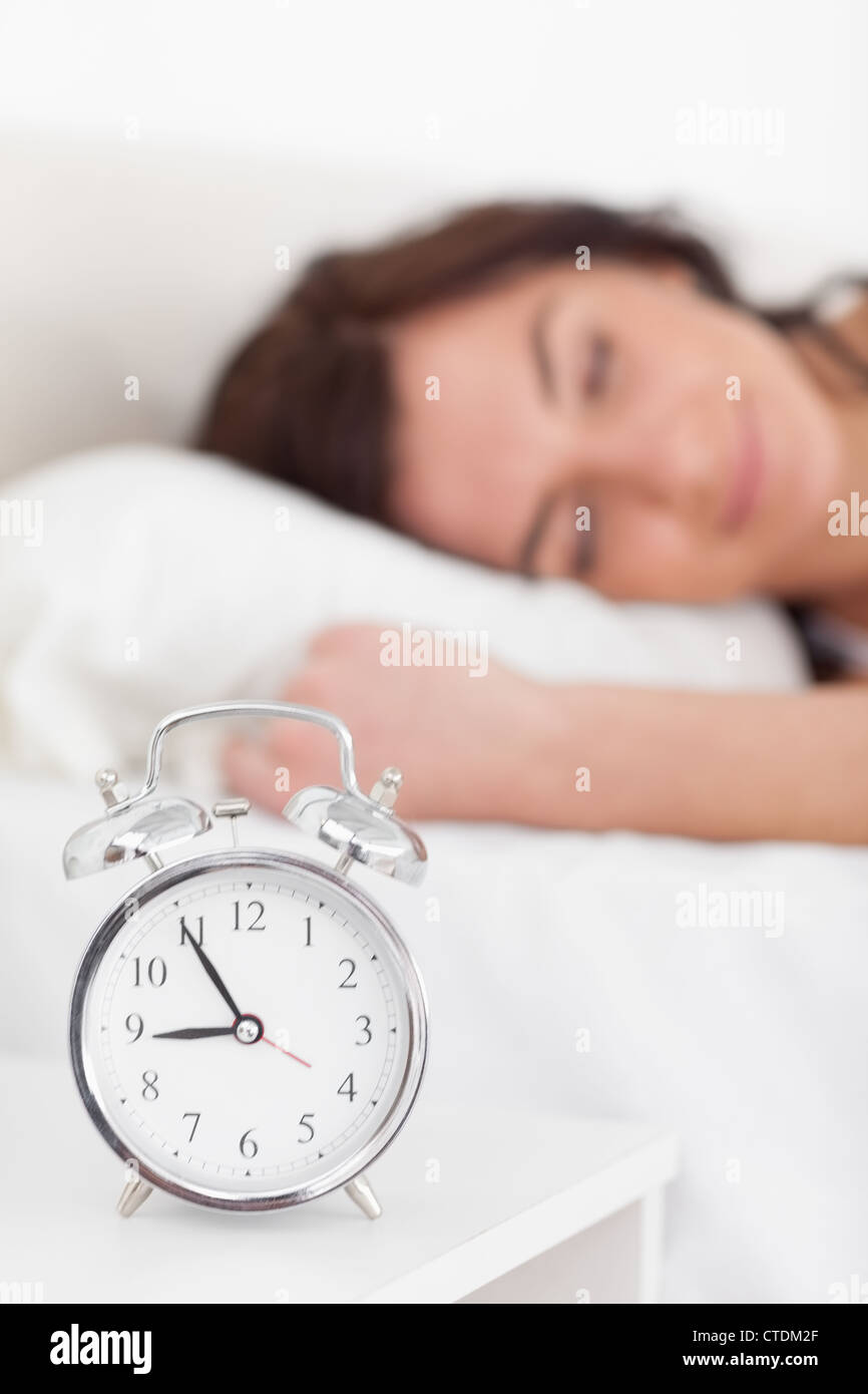 Alarm clock being placed on a nightstand Stock Photo Alamy