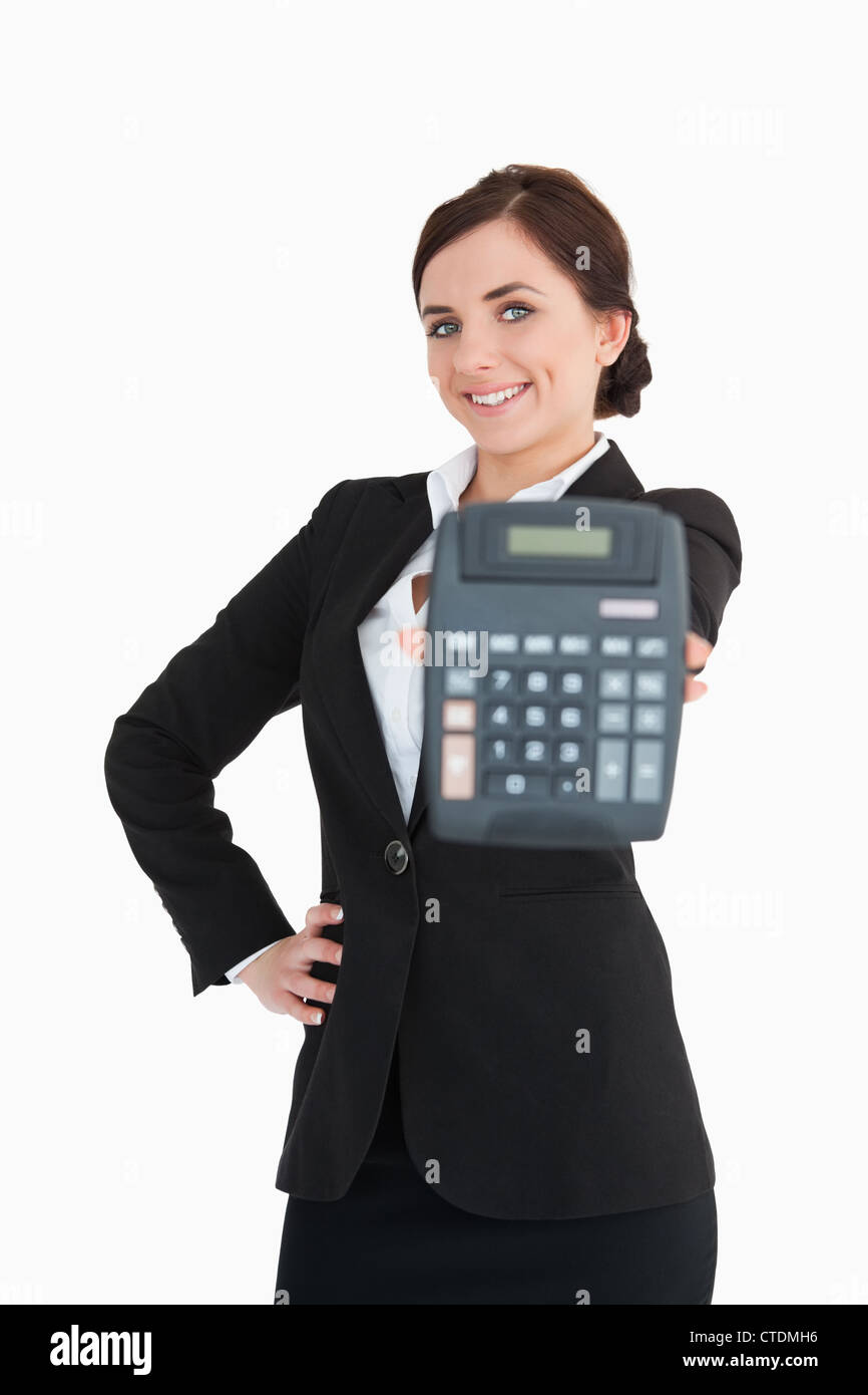 Smiling businesswoman in black suit showing a calculator Stock Photo