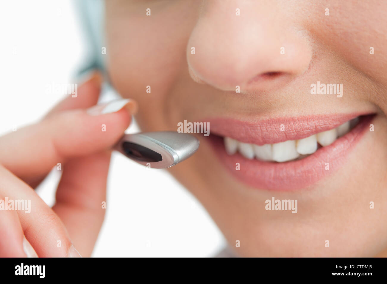 Close-up on a smiling businesswoman mouth speaking in headset Stock Photo