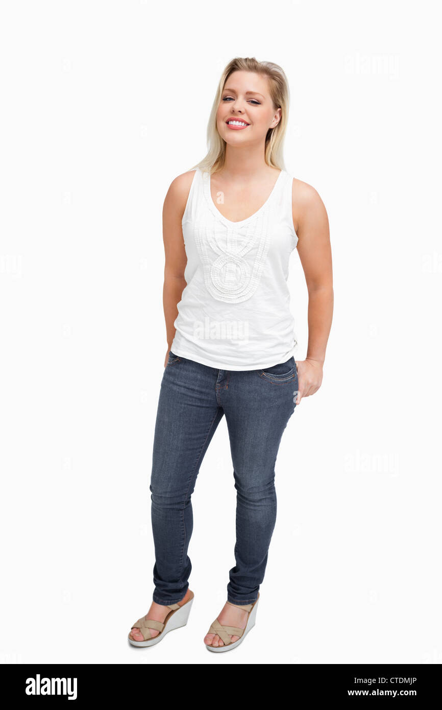 Woman standing upright with her hands in her pockets Stock Photo - Alamy