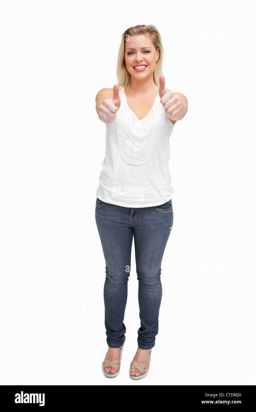 Joyful blonde woman placing her thumbs up Stock Photo - Alamy