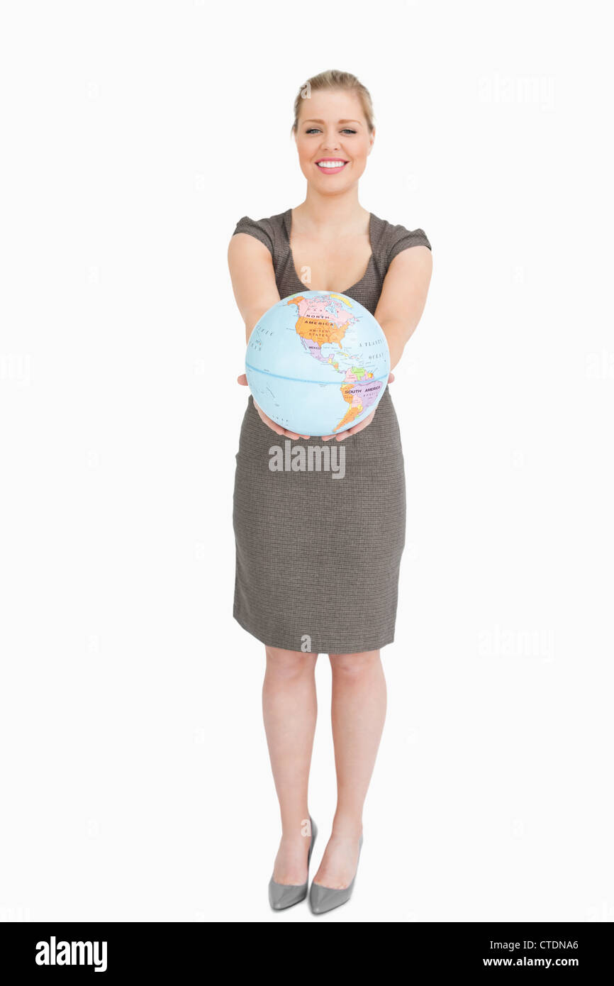 Woman smiling showing a globe Stock Photo