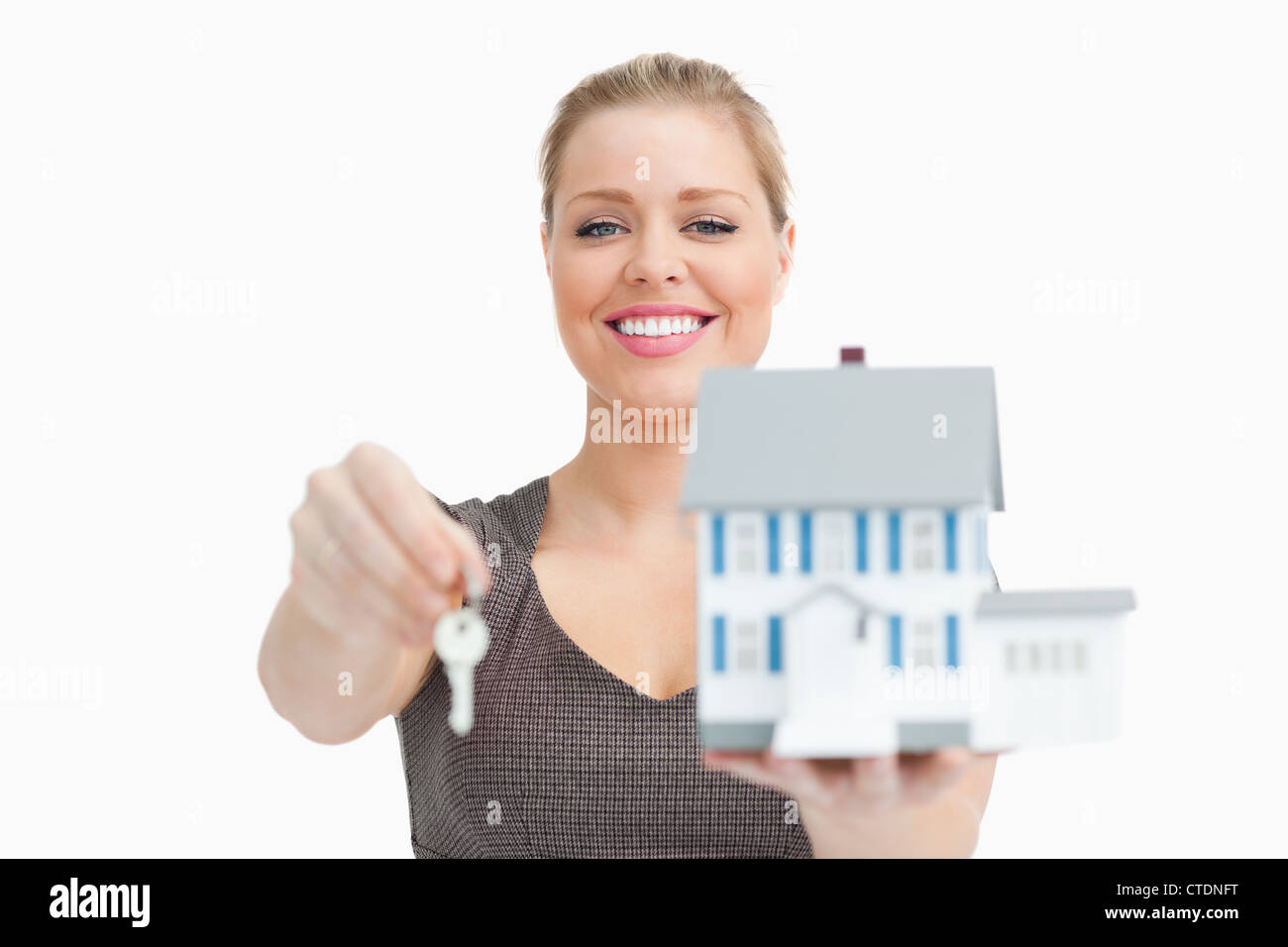 Model house and a key holding by a woman Stock Photo - Alamy