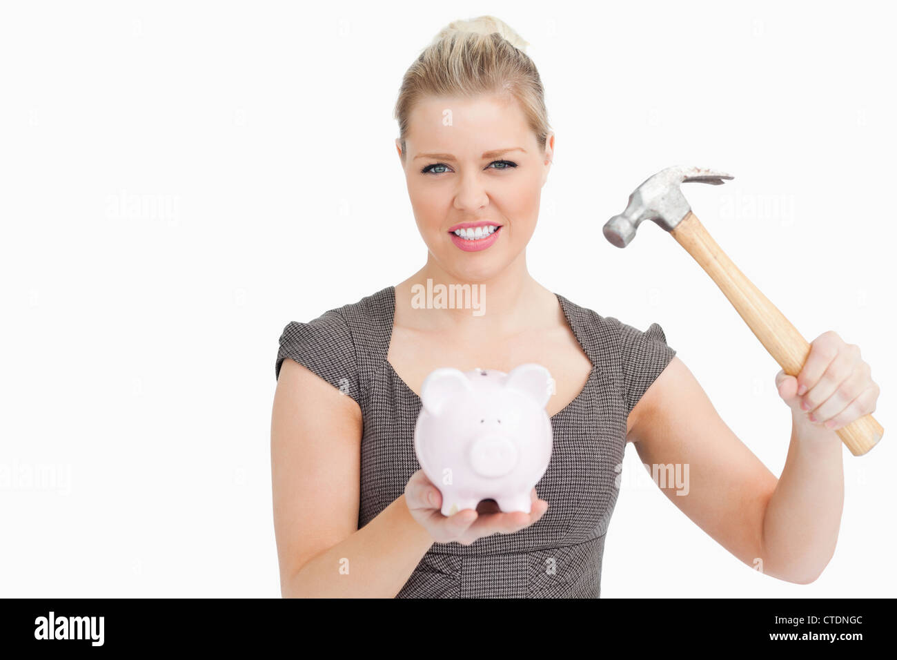 Woman want break a piggy bank with a hammer Stock Photo - Alamy