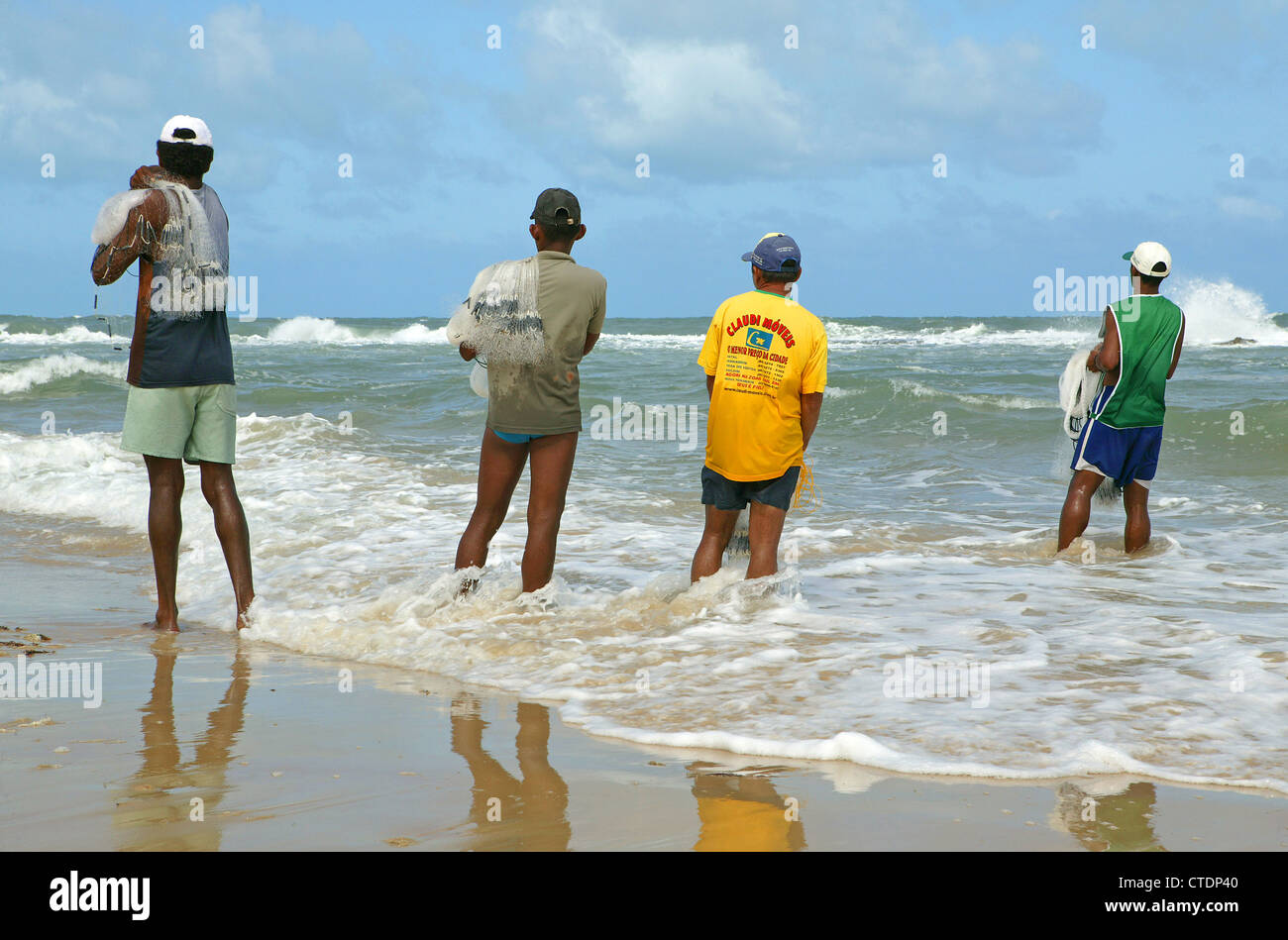 Brazil fishermen net fishing from beach in atlantic ocean sunny day Stock Photo