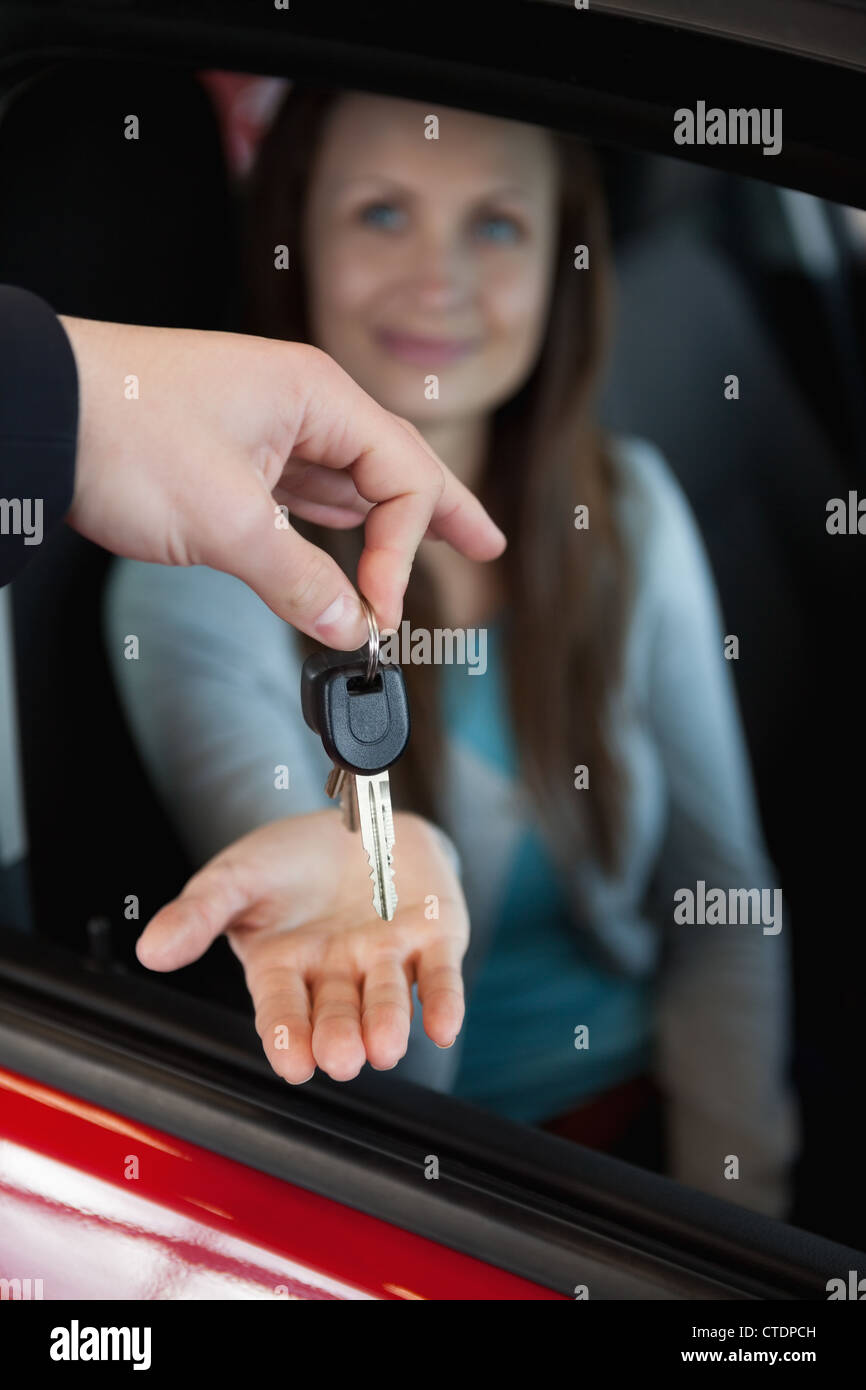 Dealer holding car keys by his fingertips Stock Photo Alamy