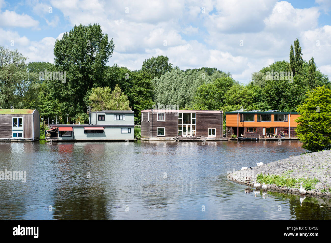 June 2012 Row of luxurious house boats along the Schinkel opposite the Olympic Stadium. Stock Photo