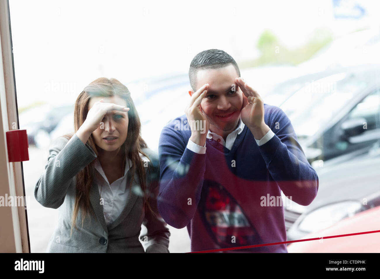 People looking through a shopwindow Stock Photo