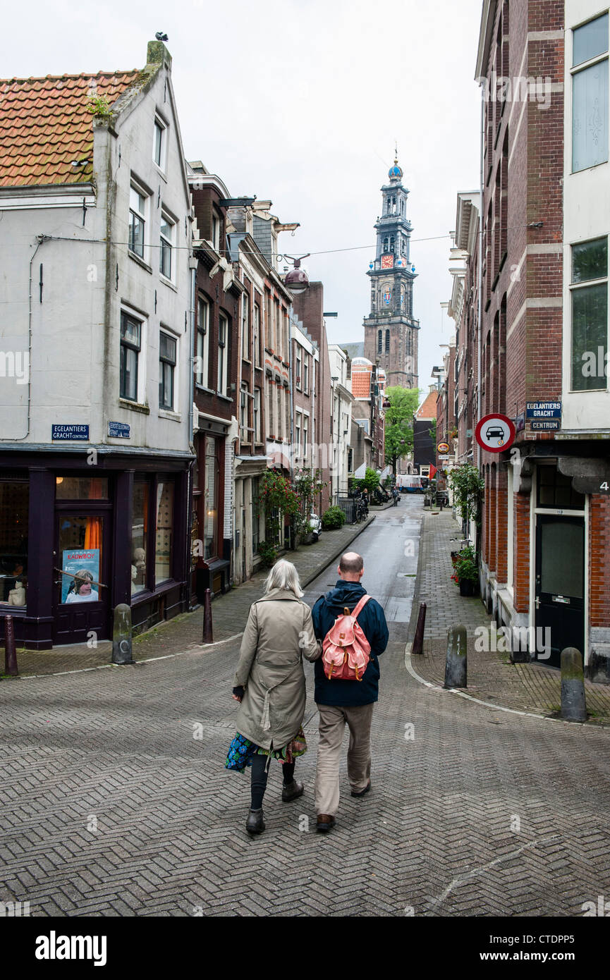 Normal street scenes in the Jordaan neighbourhood of Amsterdam. The Wester Tower as always towering over the neighbourhood. Stock Photo