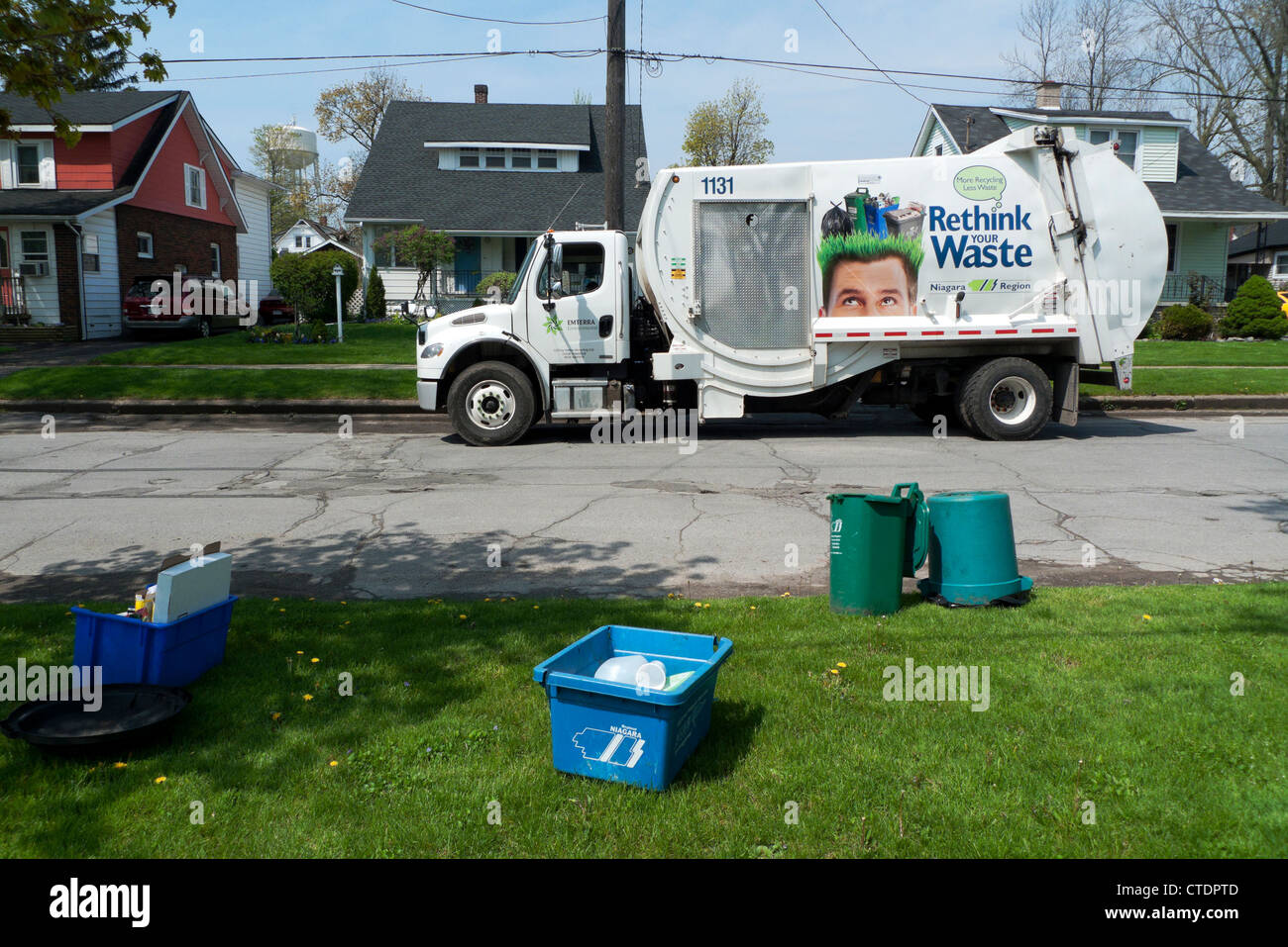 Garbage truck in residential street collecting household recycled waste paper Fort Erie Ontario Canada  KATHY DEWITT Stock Photo