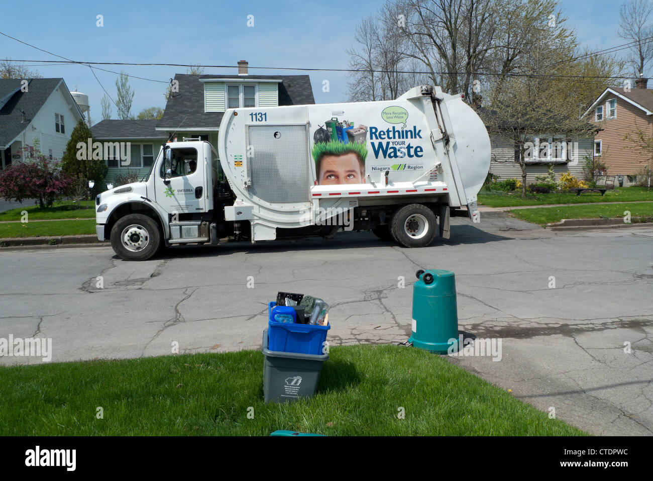 Garbage truck recycling lorry parked outside in residential street collecting household recycled paper waste Fort Erie Ontario Canada   KATHY DEWITT Stock Photo