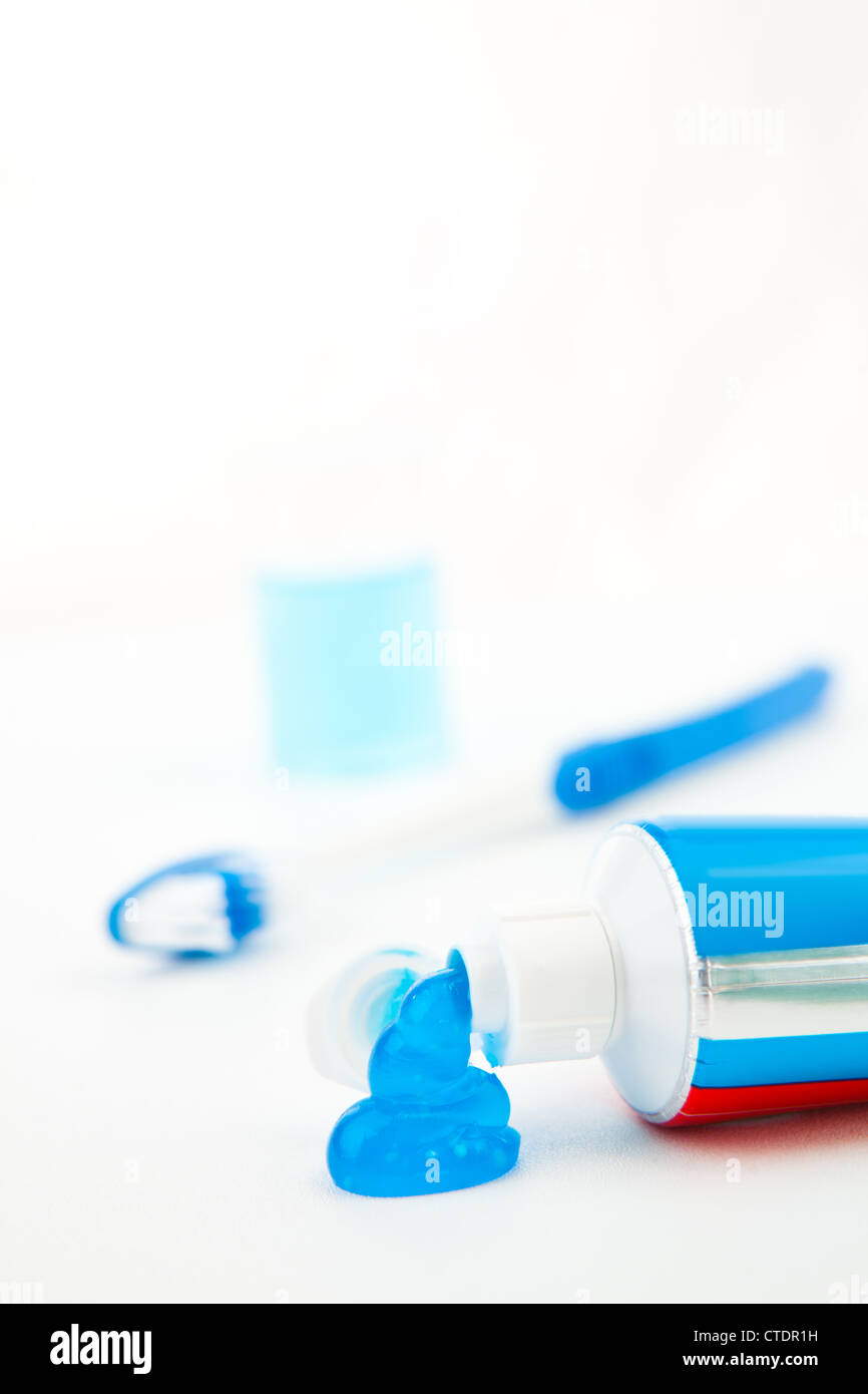 Blue toothbrush next to a tube of toothpaste Stock Photo