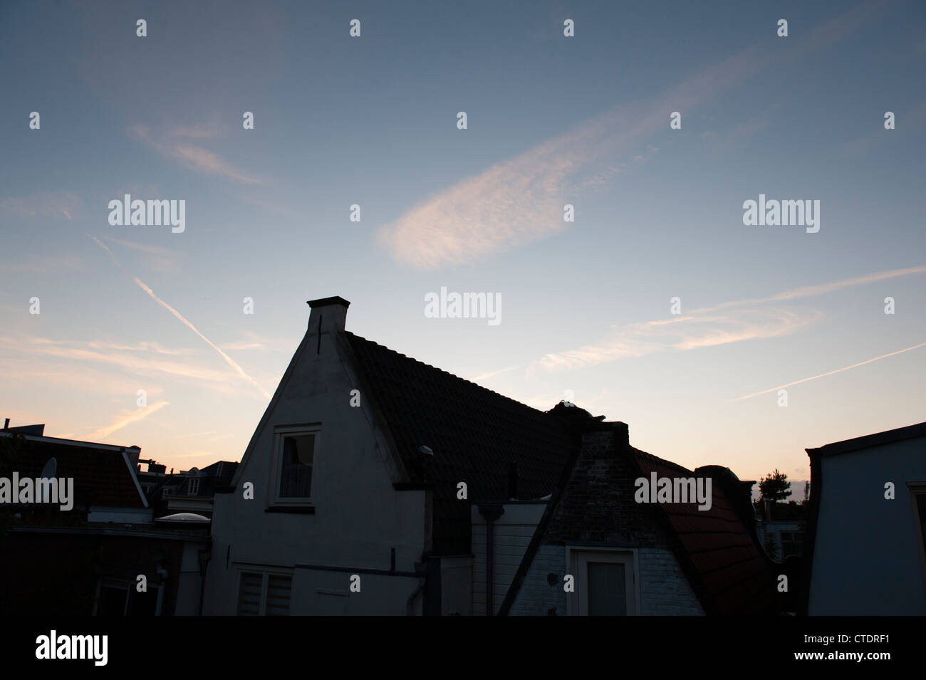 June 2012 View from the top floor from Hotel van Onna during sunset with some airplane contrails. Stock Photo