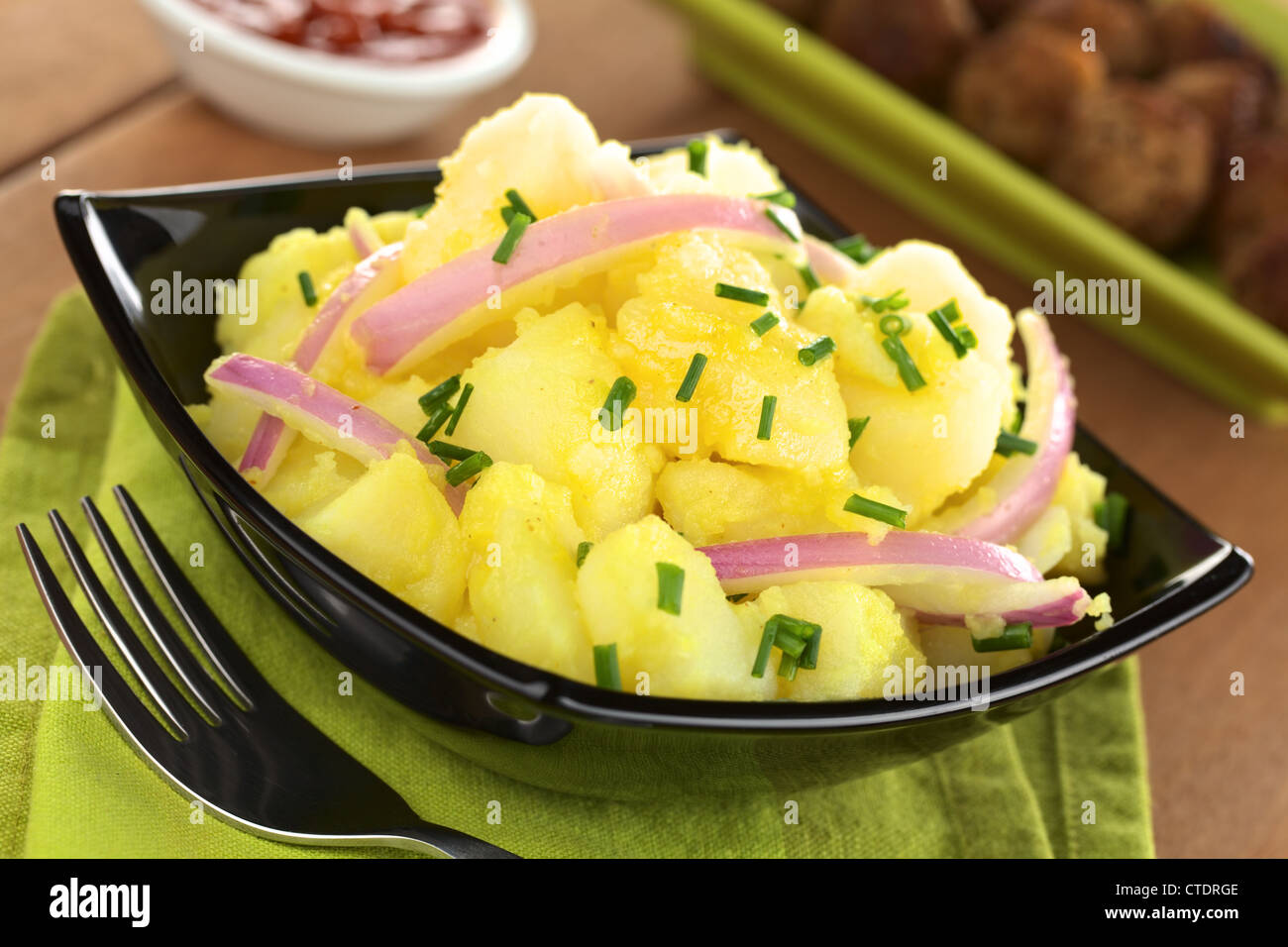 Potato salad with onions prepared in Swabian-Style (Southern Germany) with a vinegar-mustard sauce and garnished with chives Stock Photo