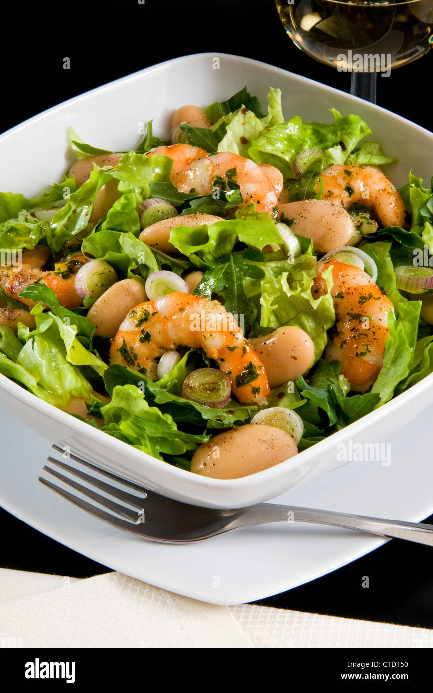 Salad with shrimp, white beans, onions and arugula with balsamic vinegar Stock Photo