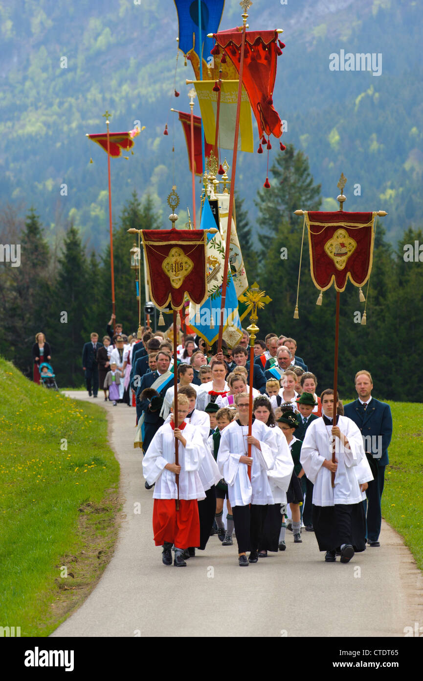 traditional and catholic procession in Bavaria, Germany, in village Jachenau with praying people in typical Bavarian clothes Stock Photo