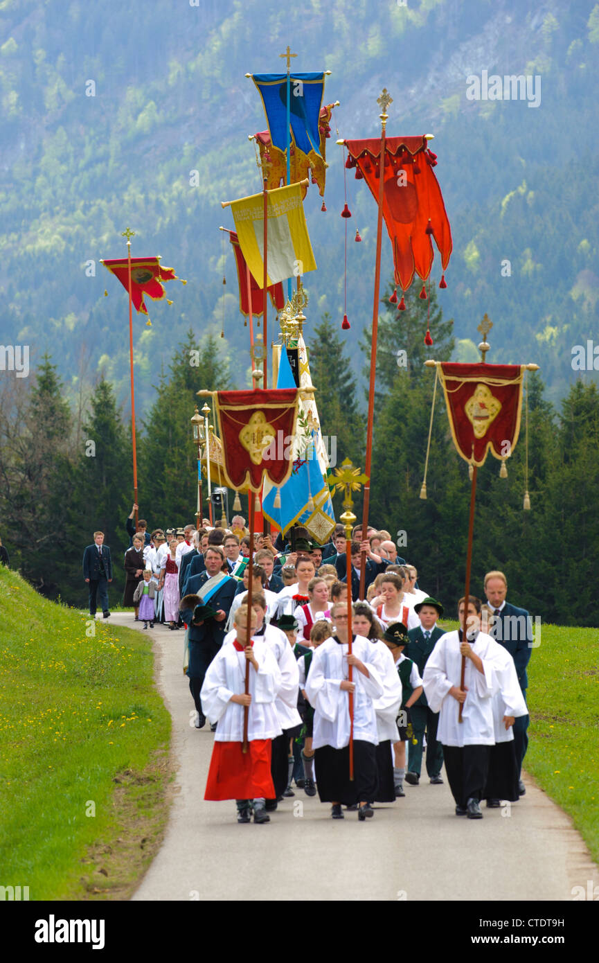 traditional and catholic procession in Bavaria, Germany, in village Jachenau with praying people in typical Bavarian clothes Stock Photo