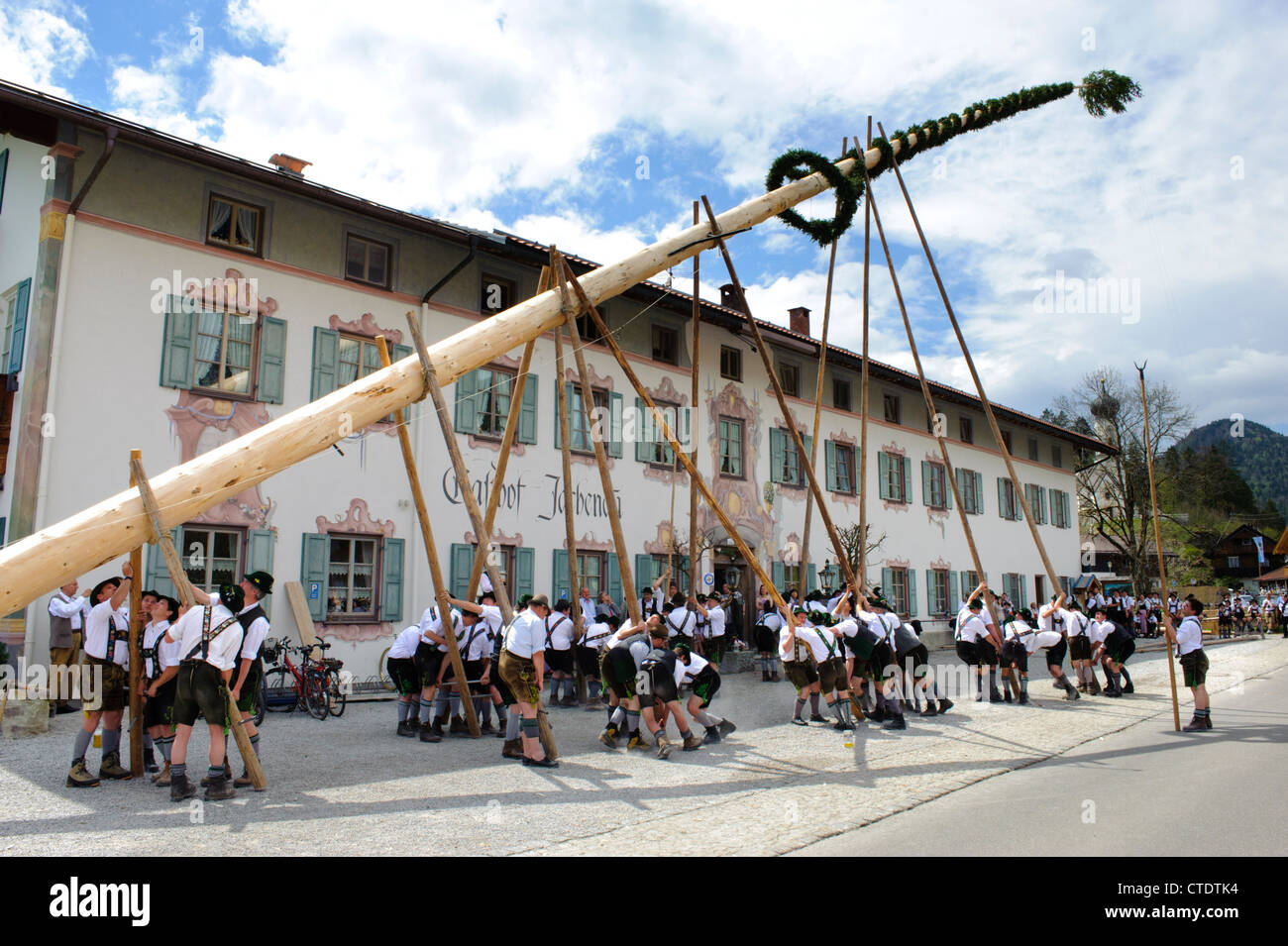 annual tradition in Bavaria, Jachenau, Germany, is the erection of an decorated tree by hand and many mens at 1st May Stock Photo