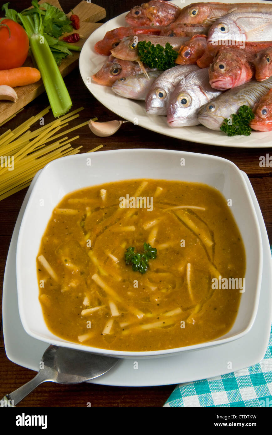 Fish soup Bisque with pieces of flat pasta linguine or linguini