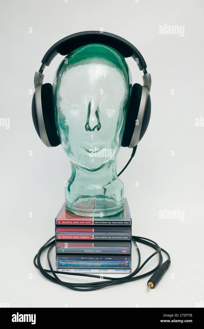 Glass head with headphones on a pile of Grateful Dead CD's Stock Photo