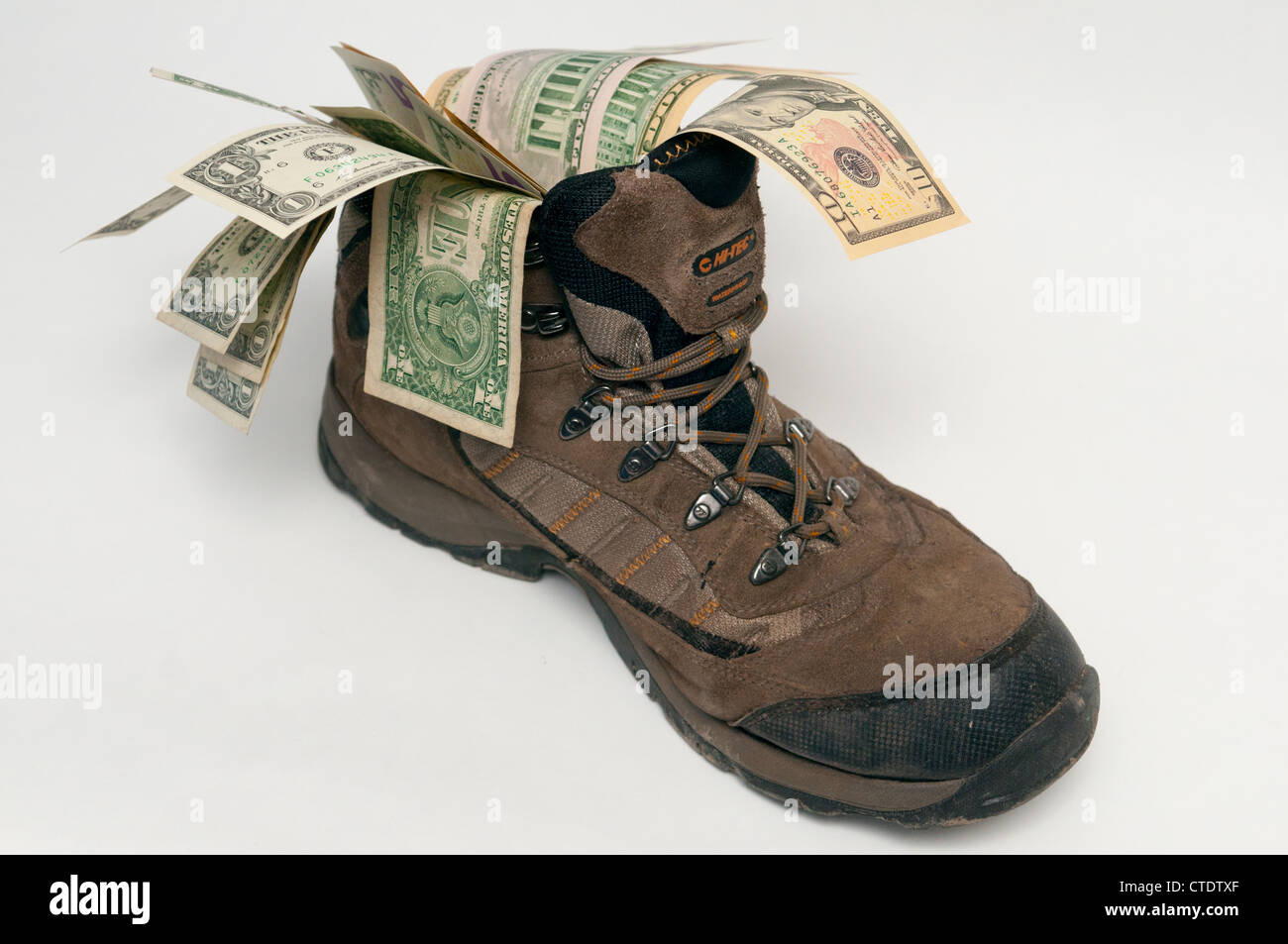 Walking boot full of travel money Stock Photo