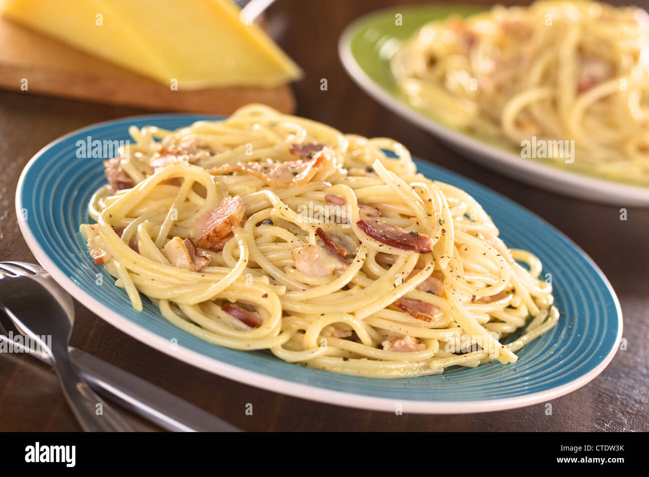 Spaghetti alla Carbonara made with bacon, eggs, cheese and black pepper (Selective Focus, Focus one third into the meal) Stock Photo